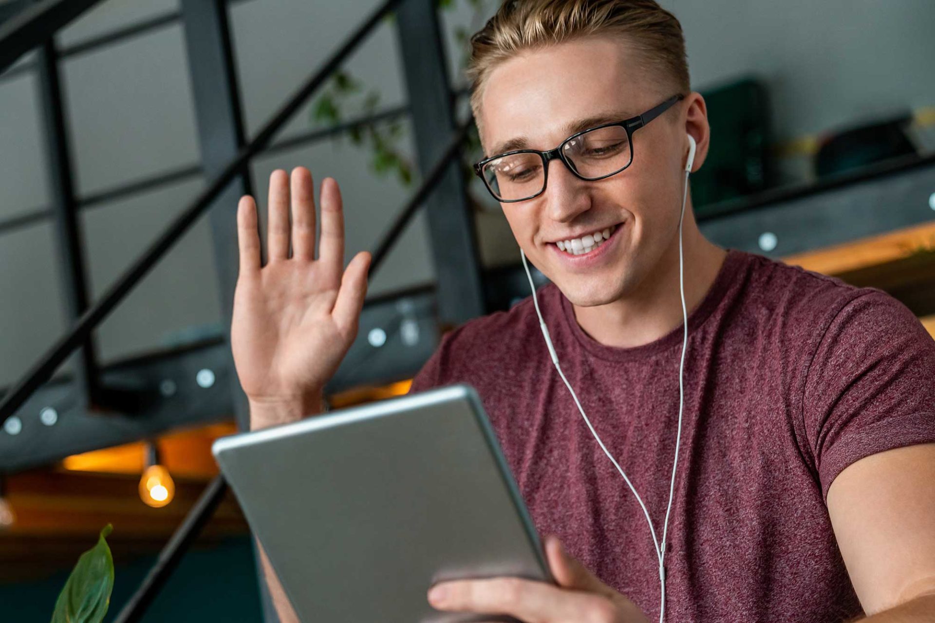 Teleconferencing young man with tablet